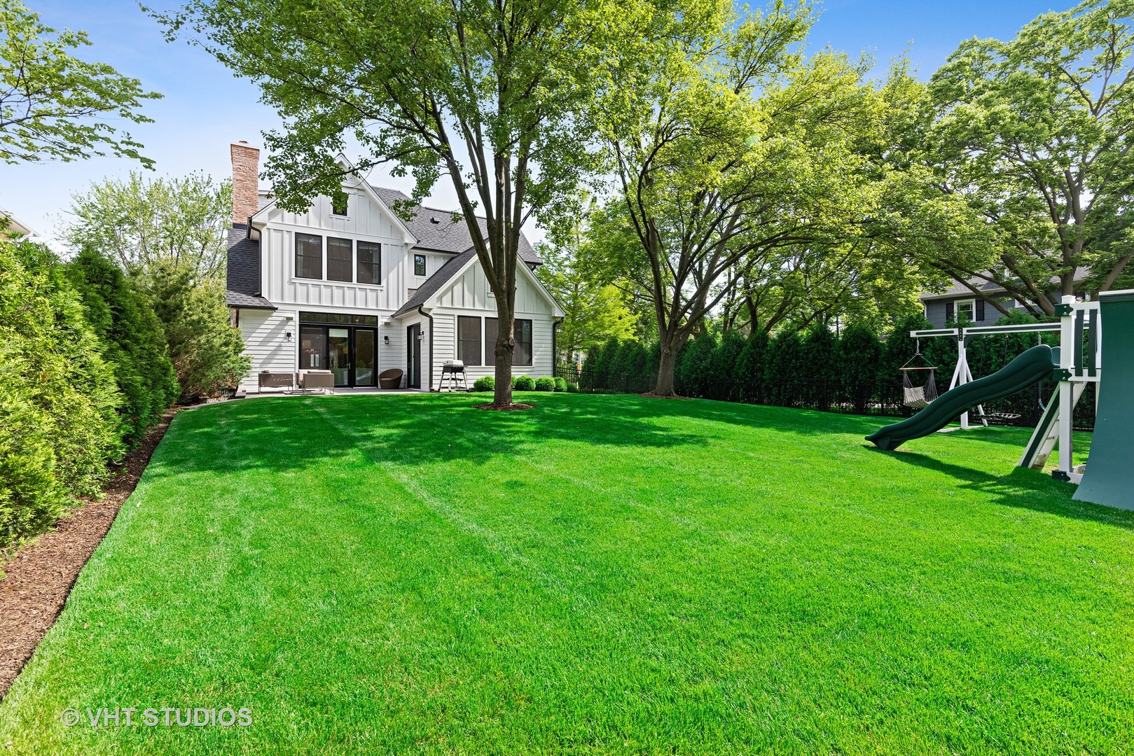 300 Greenleaf Avenue Wilmette, IL 60091 - Photo 37 of 43 a view of a house with a big yard and large trees