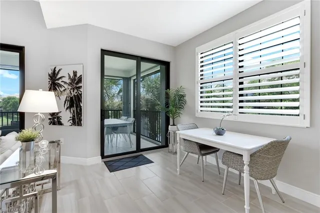 a view of a dining room with furniture and window