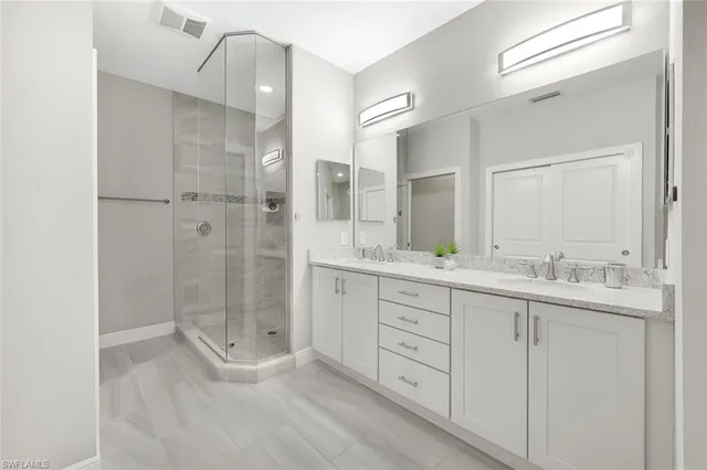 a bathroom with a granite countertop sink mirror and double