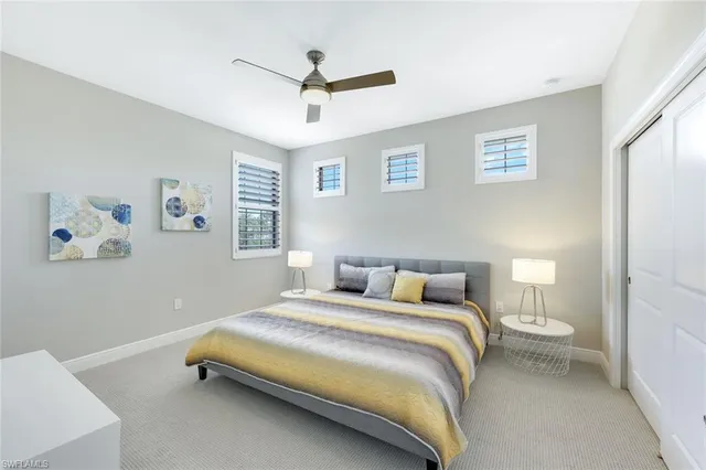 a bedroom with a bed and a ceiling fan