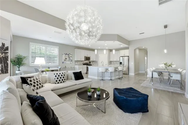 a living room with furniture and a chandelier