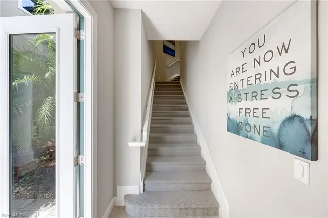 a view of a hallway with wooden floor and windows