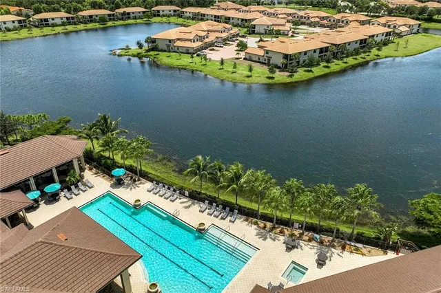 an aerial view of a house with outdoor space lake view and boat