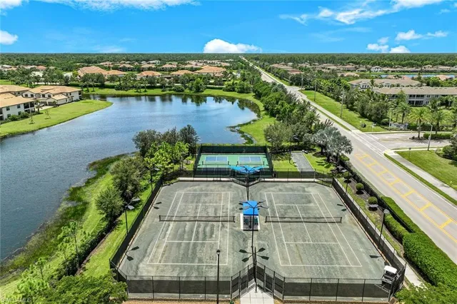 a front view of a house with a yard and potted plants