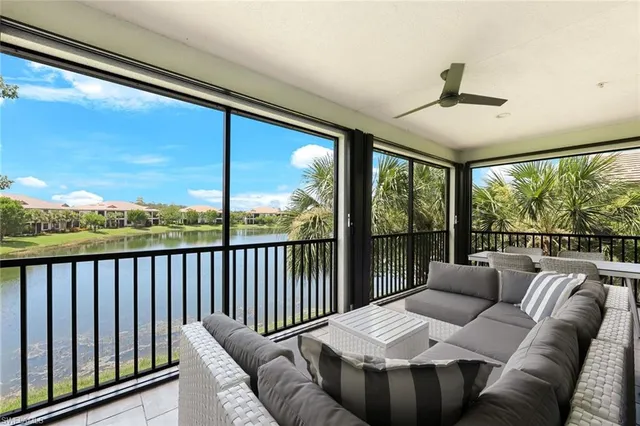 a living room with furniture and a floor to ceiling window