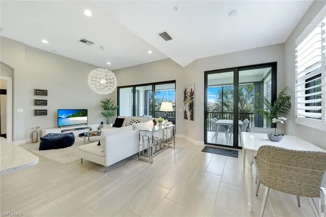 a living room with fireplace furniture and a large window