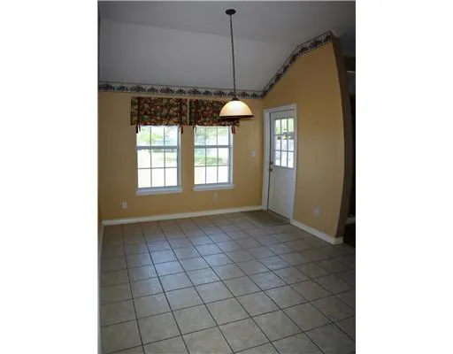 a view of an empty room with windows