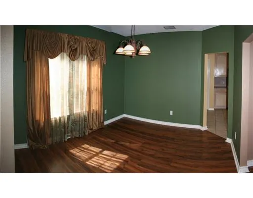 a living room with a bed furniture and a large window