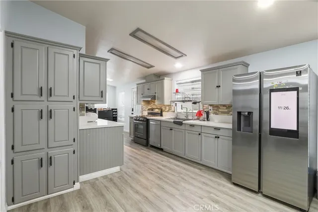 a kitchen with white cabinets and white appliances
