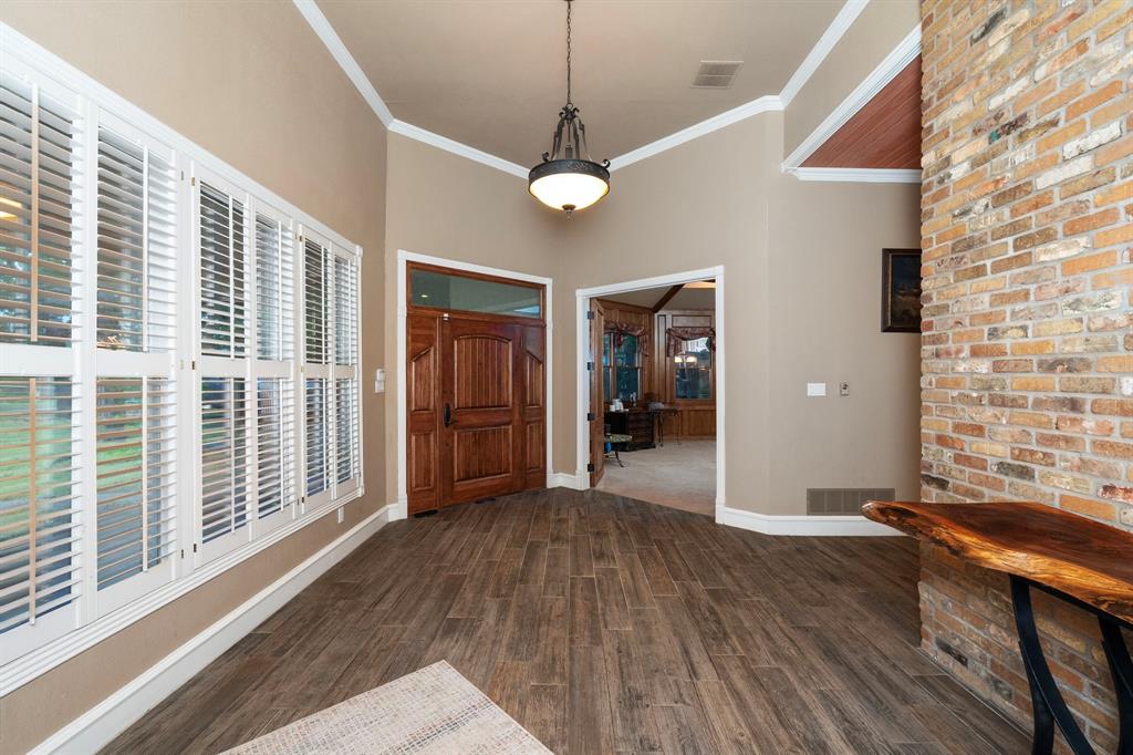 10080 Arvin Hill Road Aubrey, TX 76227 - Photo 11 of 40 a view of a livingroom with furniture wooden floor and windows