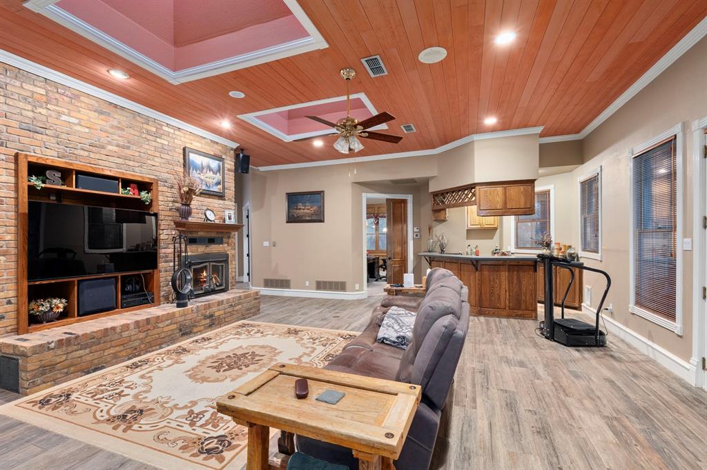 10080 Arvin Hill Road Aubrey, TX 76227 - Photo 14 of 40 a living room with furniture and a flat screen tv