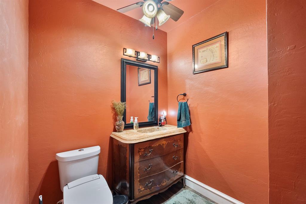 10080 Arvin Hill Road Aubrey, TX 76227 - Photo 17 of 40 a bathroom with a toilet sink and mirror