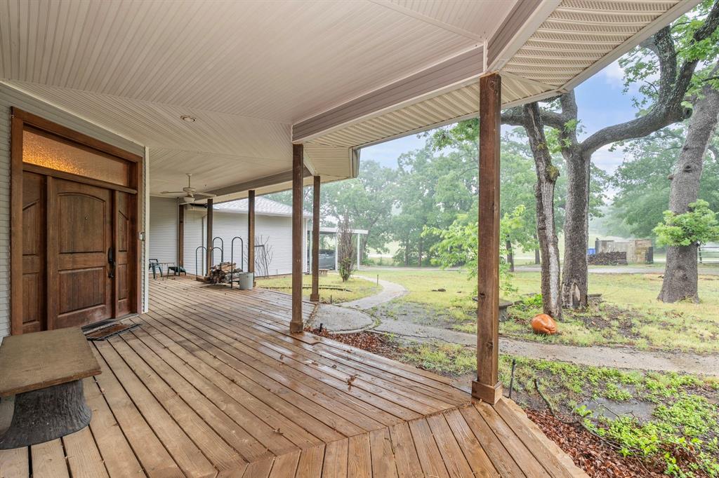 10080 Arvin Hill Road Aubrey, TX 76227 - Photo 2 of 40 a view of a room with wooden floor and floor to ceiling window