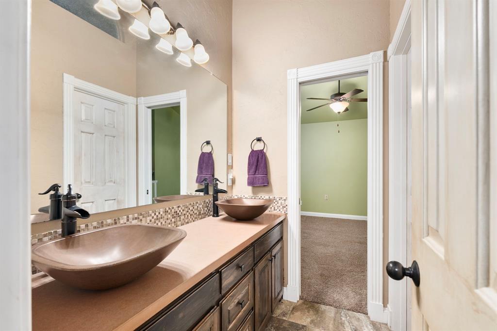 10080 Arvin Hill Road Aubrey, TX 76227 - Photo 25 of 40 a bathroom with a sink and a mirror