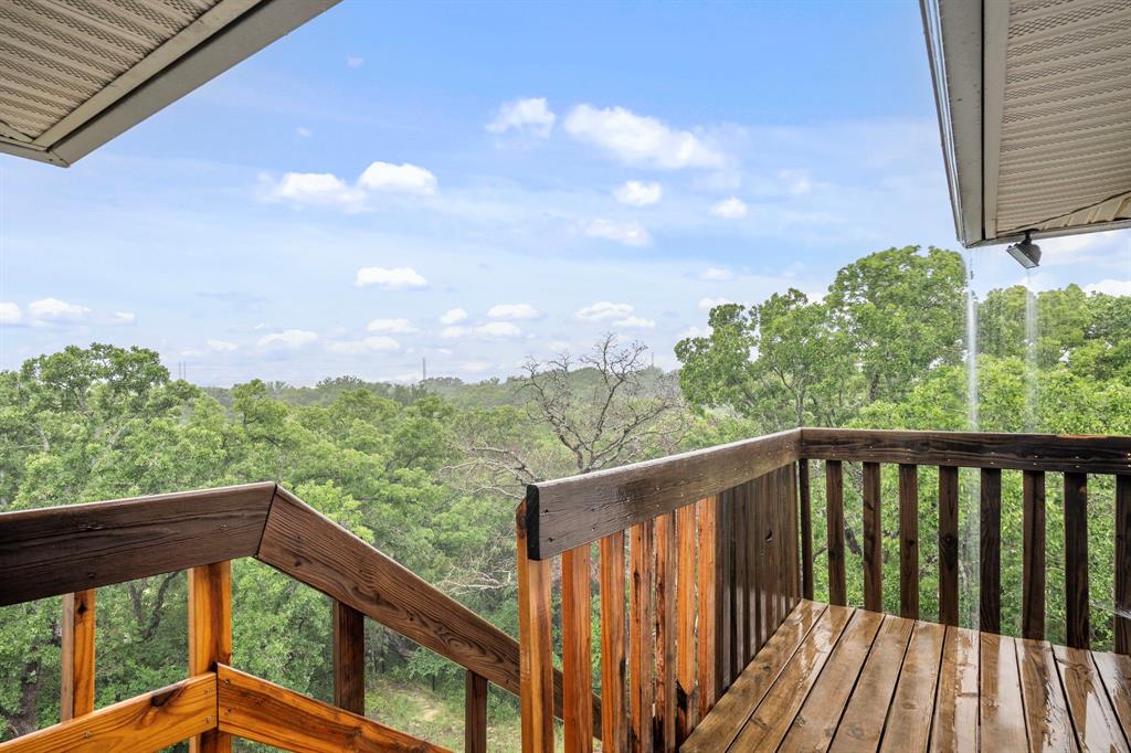 10080 Arvin Hill Road Aubrey, TX 76227 - Photo 6 of 40 a view of a balcony with wooden floor & fence
