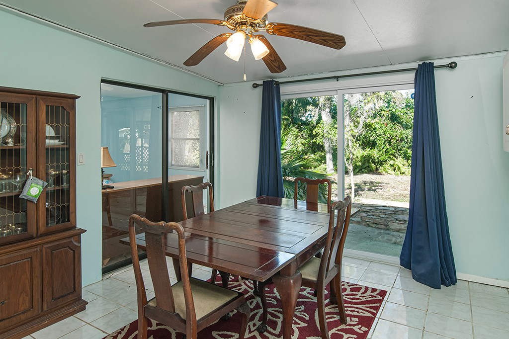 575 Acacia Road Vero Beach, FL 32963 - Photo 13 of 28 a view of a dining room with furniture window and wooden floor