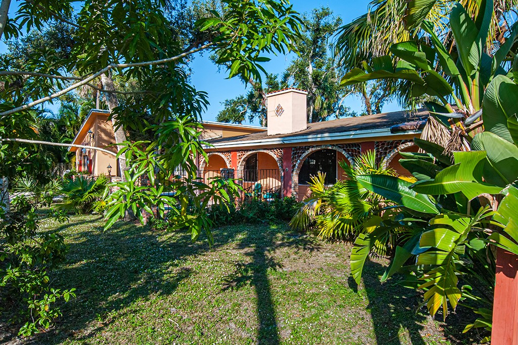 575 Acacia Road Vero Beach, FL 32963 - Photo 14 of 28 a view of a garden with plants and large trees