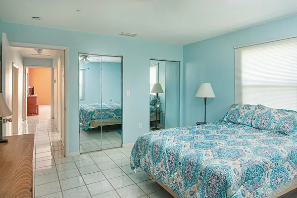 a bedroom with a large bed and a chandelier