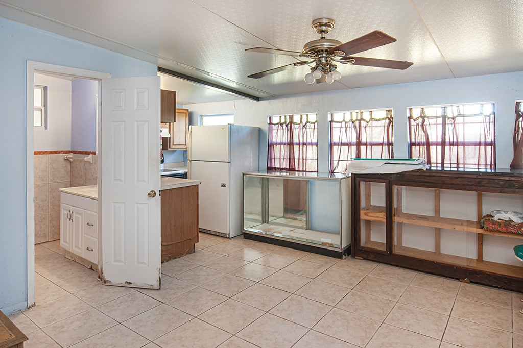 575 Acacia Road Vero Beach, FL 32963 - Photo 23 of 28 a kitchen with a stove a refrigerator and white cabinets