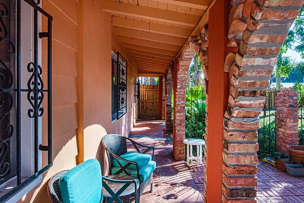 a view of a patio with table and chairs and potted plants