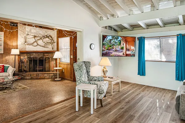 a dining room with furniture a fireplace and wooden floor
