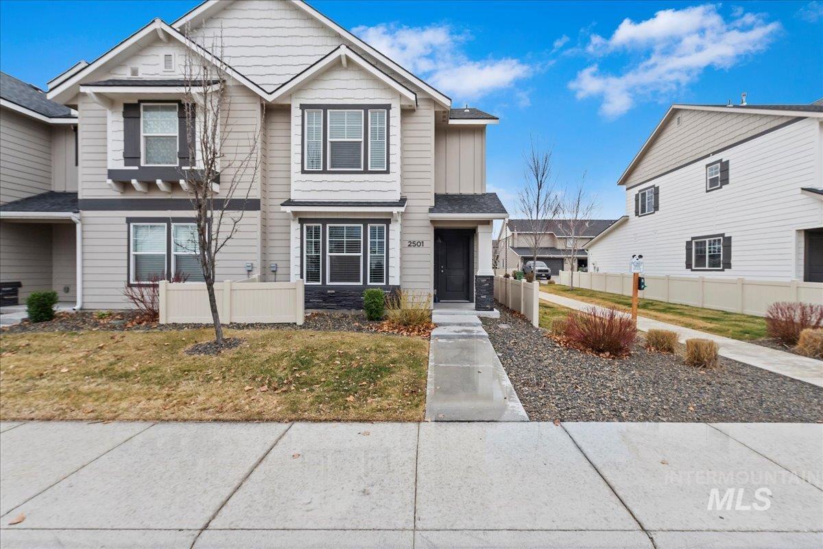 View of front of property with stone siding and board and batten siding