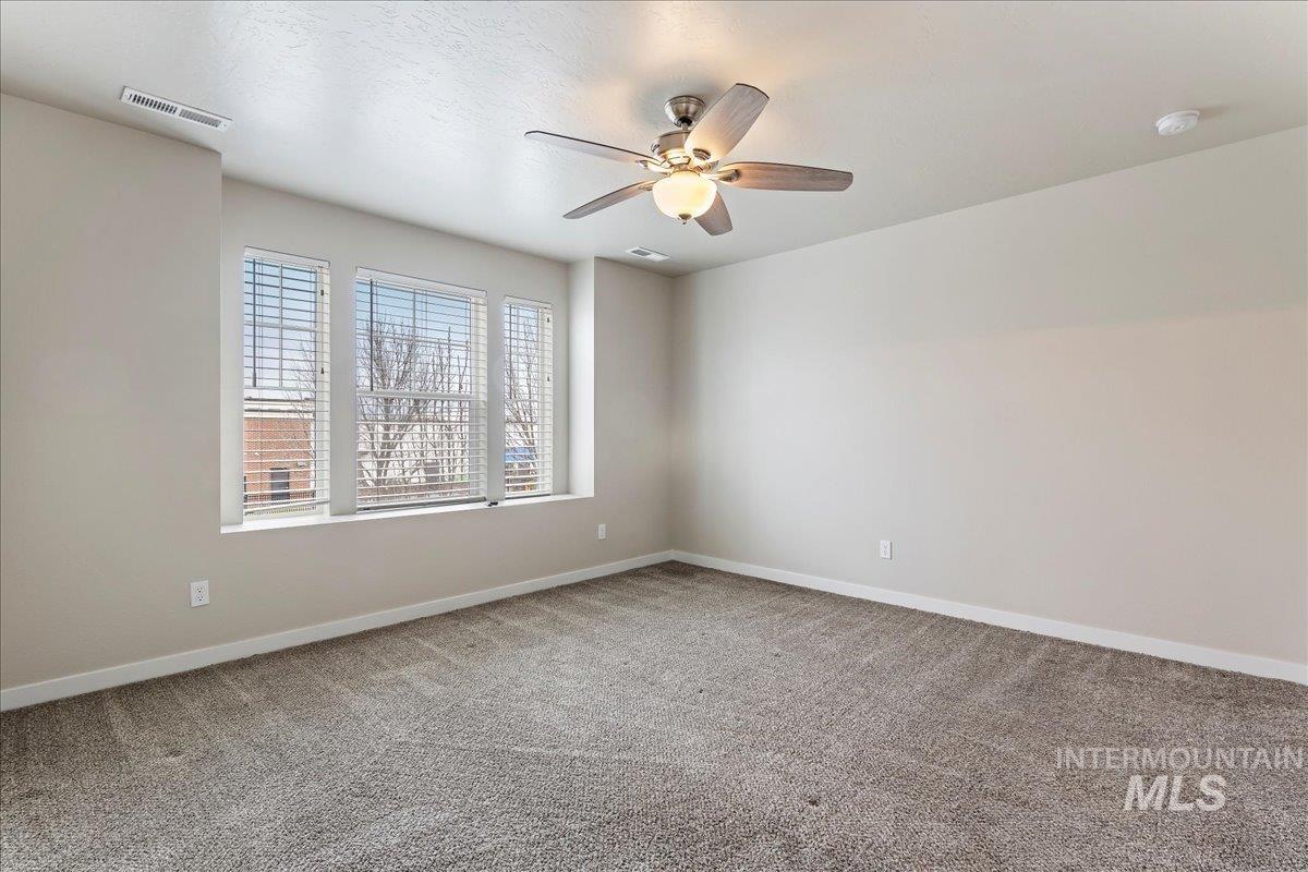 2501 East Goldstone Street Meridian, ID 83642 - Photo 14 of 26 Spare room with light carpet and a ceiling fan