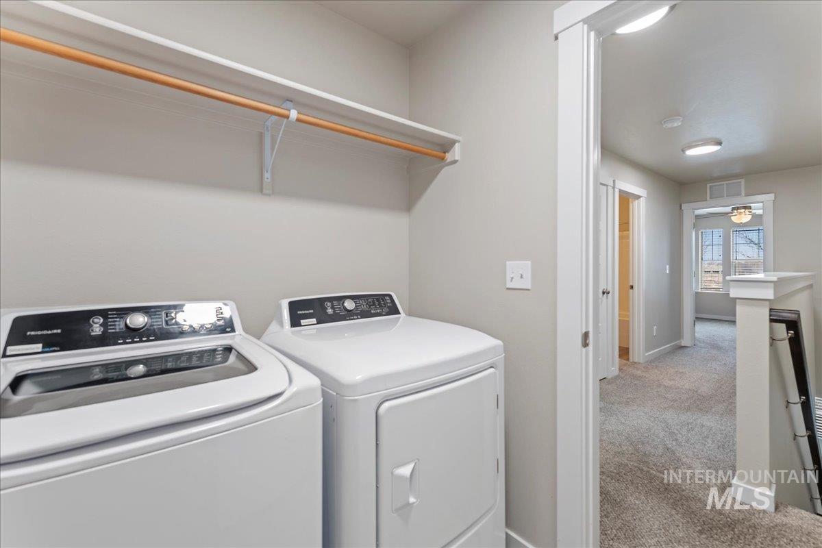 2501 East Goldstone Street Meridian, ID 83642 - Photo 18 of 26 Laundry room featuring carpet floors and washing machine and dryer