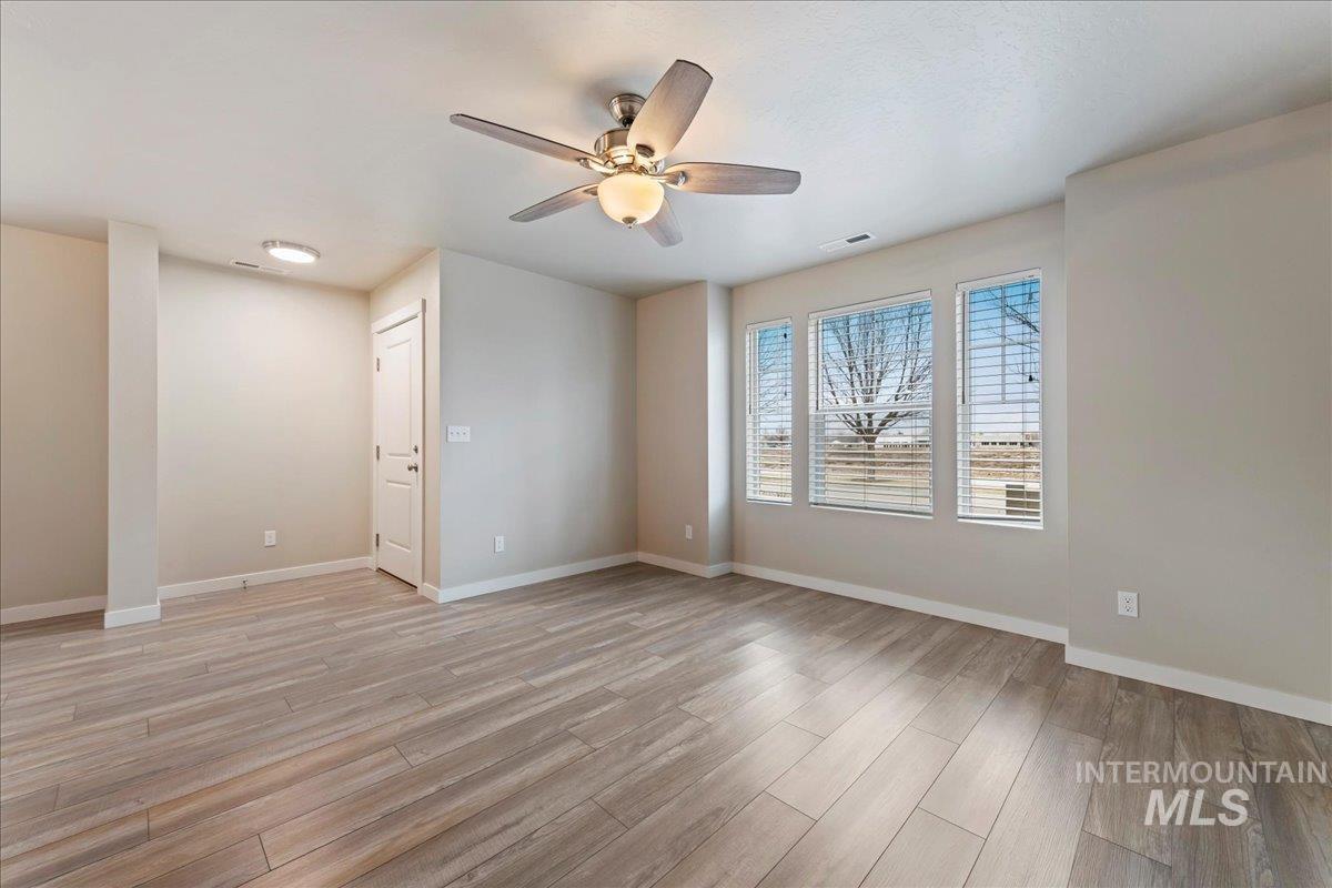 2501 East Goldstone Street Meridian, ID 83642 - Photo 5 of 26 Unfurnished room featuring a ceiling fan and light wood-style floors
