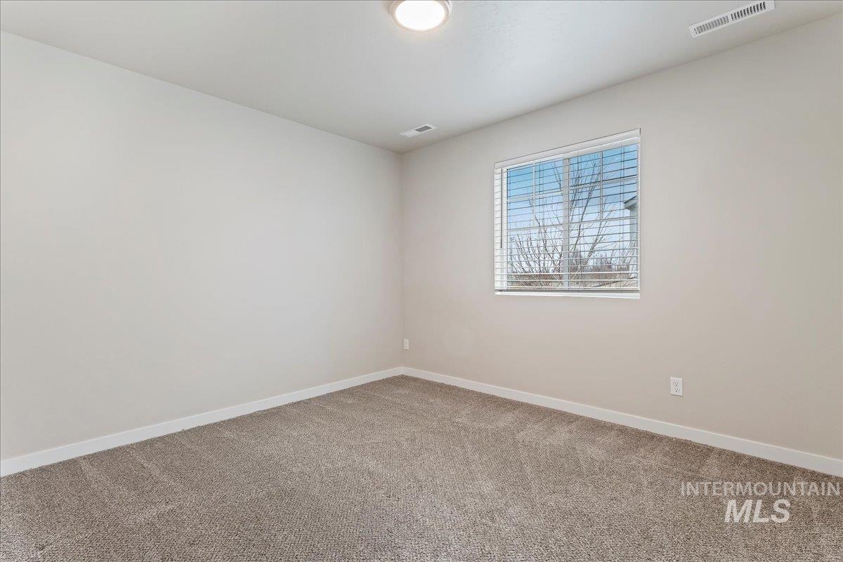 2501 East Goldstone Street Meridian, ID 83642 - Photo 10 of 26 Spare room with light colored carpet and baseboards