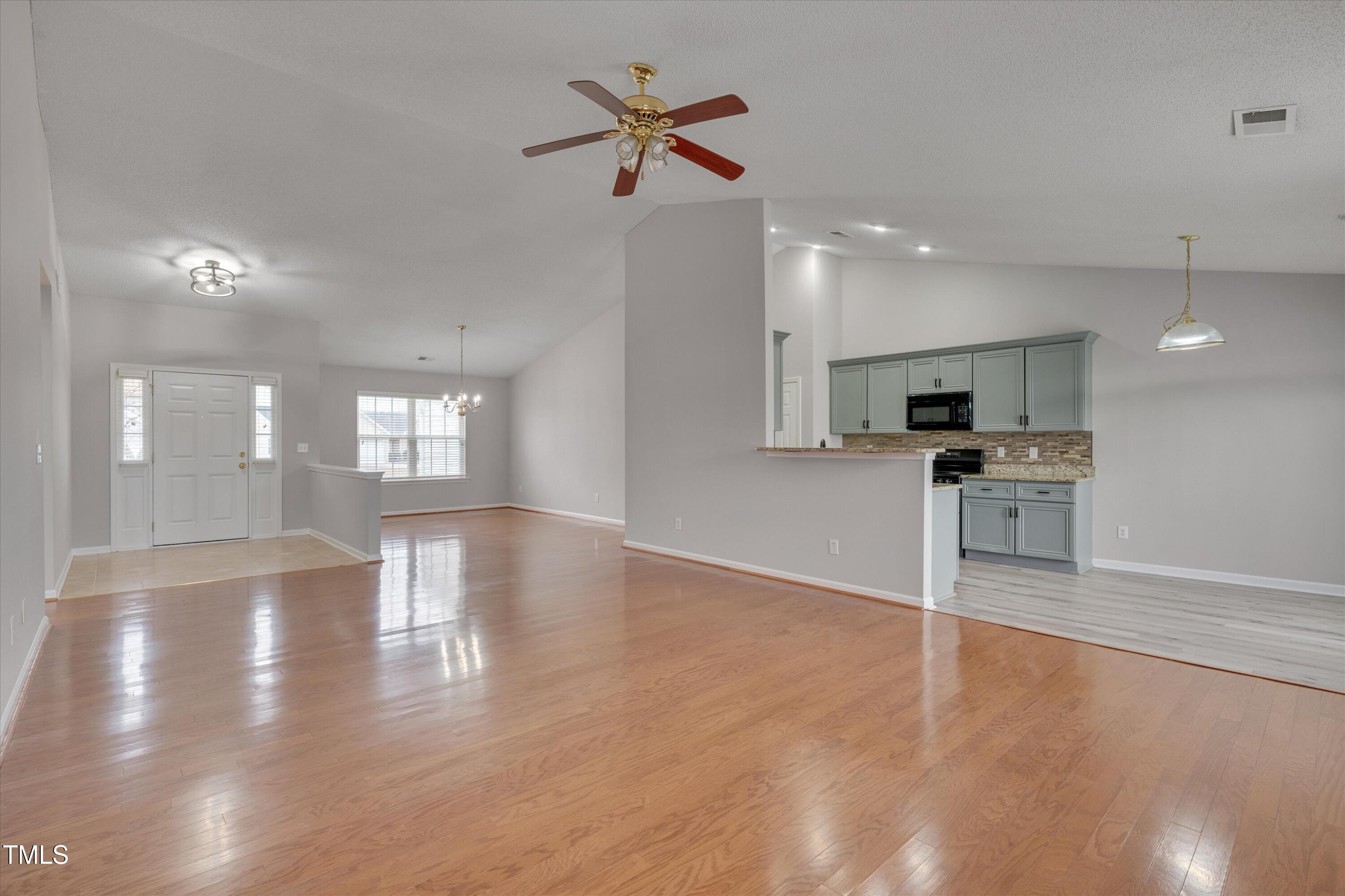 3217 Flowery Branch Road Raleigh, NC 27610 - Photo 3 of 12 a view of an empty room with kitchen and window