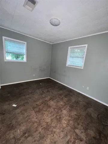 a view of a room with wooden floor and window