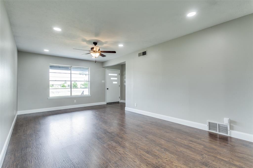 925 West Lucas Road Lucas, TX 75002 - Photo 2 of 23 an empty room with wooden floor ceiling fan and windows