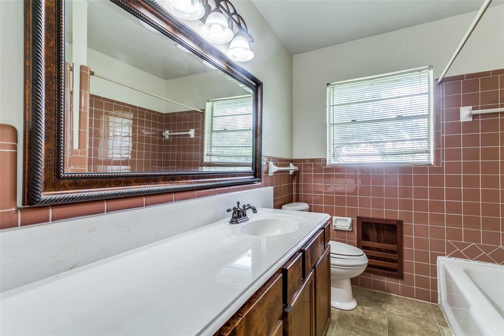 925 West Lucas Road Lucas, TX 75002 - Photo 21 of 23 a bathroom with a sink a toilet and a mirror
