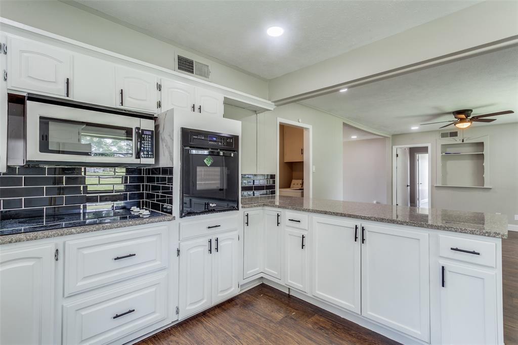 925 West Lucas Road Lucas, TX 75002 - Photo 10 of 23 a kitchen with granite countertop white cabinets and stainless steel appliances