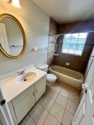 a bathroom with a sink and a mirror with bathtub