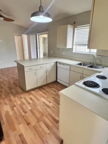 a kitchen that has a sink and a stove in it