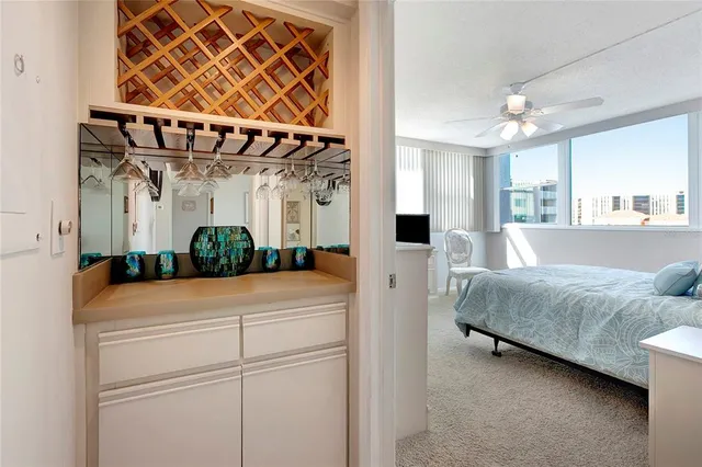 a bedroom with a bed and a flat tv screen on dresser