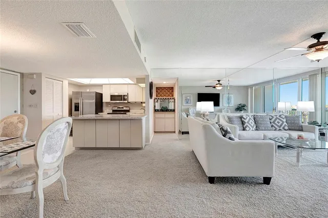 a kitchen with granite countertop a refrigerator and a stove top oven
