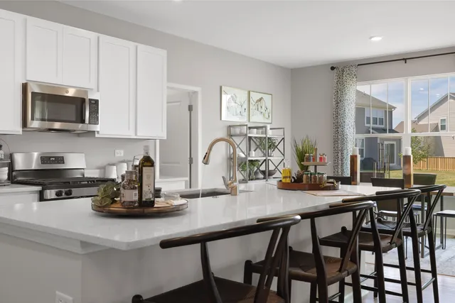 a kitchen with sink a microwave and cabinets
