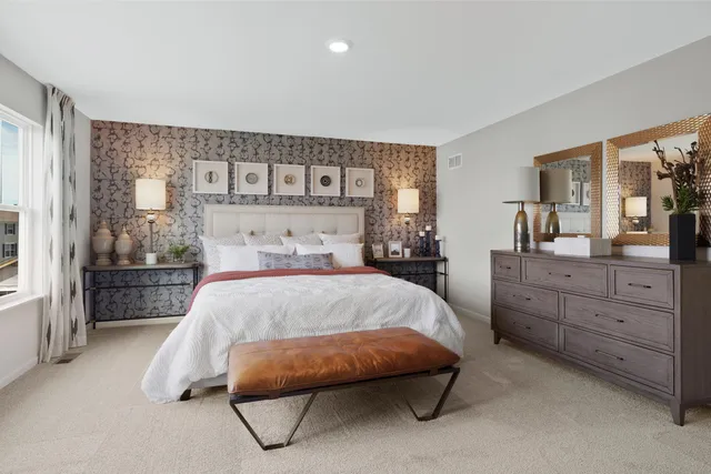 a bedroom with a bed and a dresser