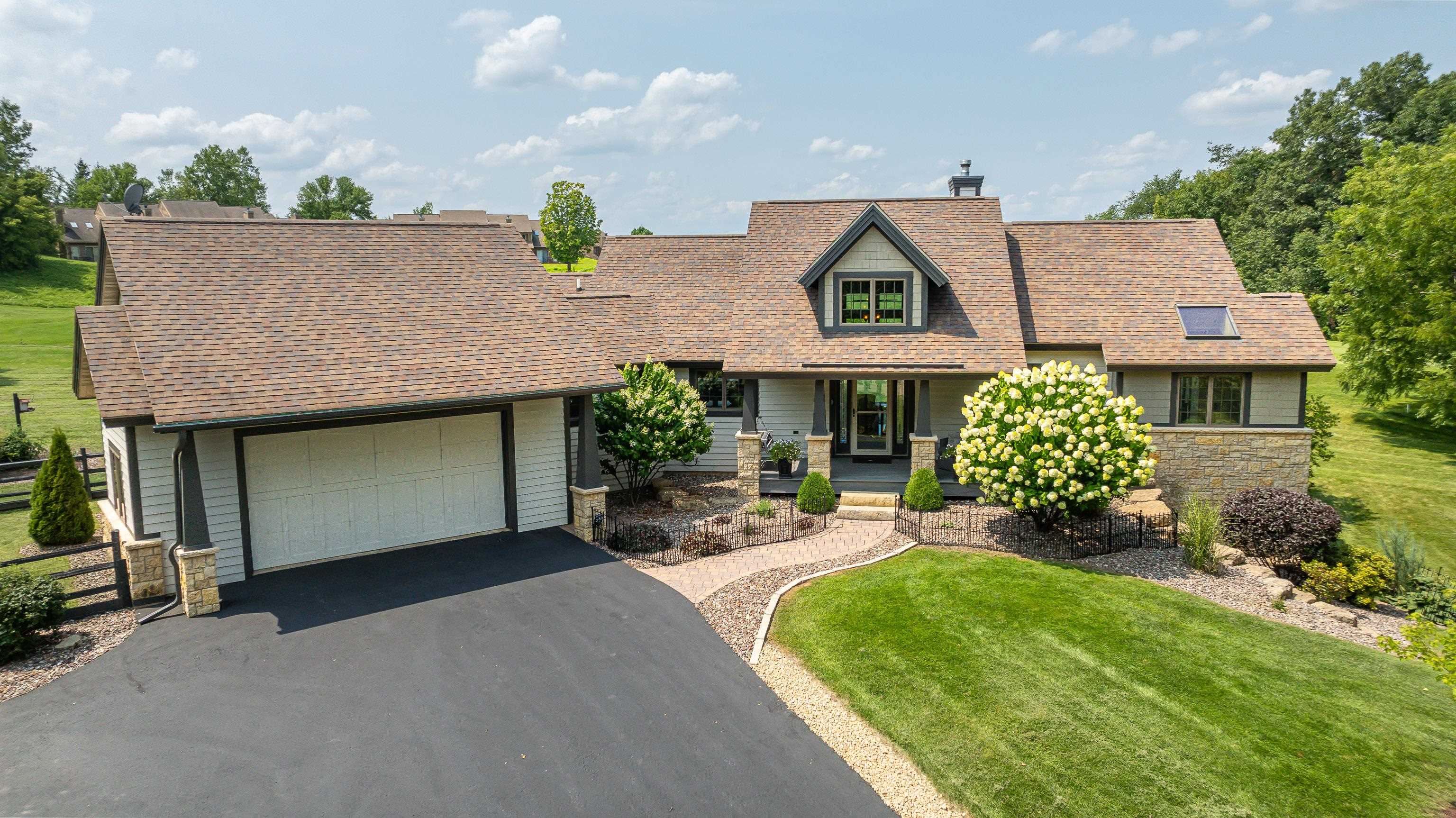 an aerial view of a house with sitting area and garden