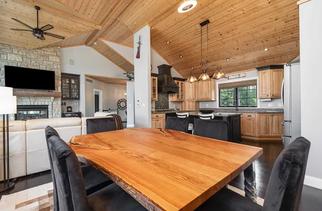 a bedroom with a large bed and a flat tv screen on dresser