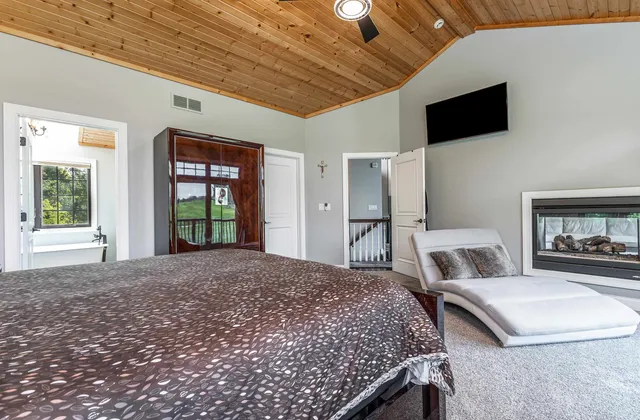 a bed room with a bed and a painting on the wall