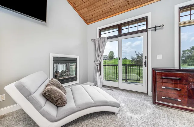 a bedroom with bed and paintings on the wall