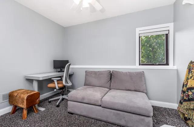 an aerial view of a house with pool big yard and large trees
