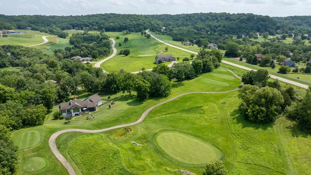 an aerial view of a house with yard swimming pool and outdoor seating