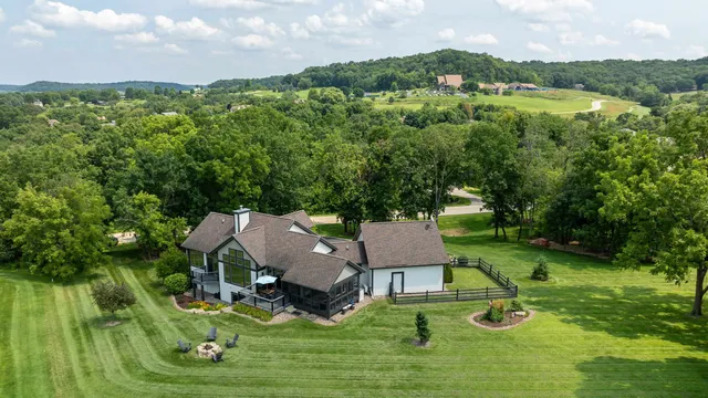 an aerial view of a house with swimming pool garden and patio