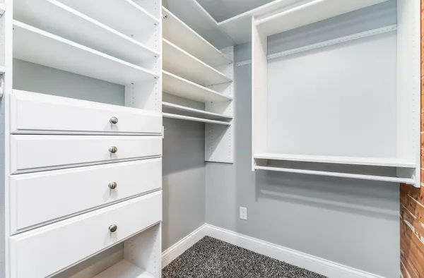 a bed room with a bed and a painting on the wall
