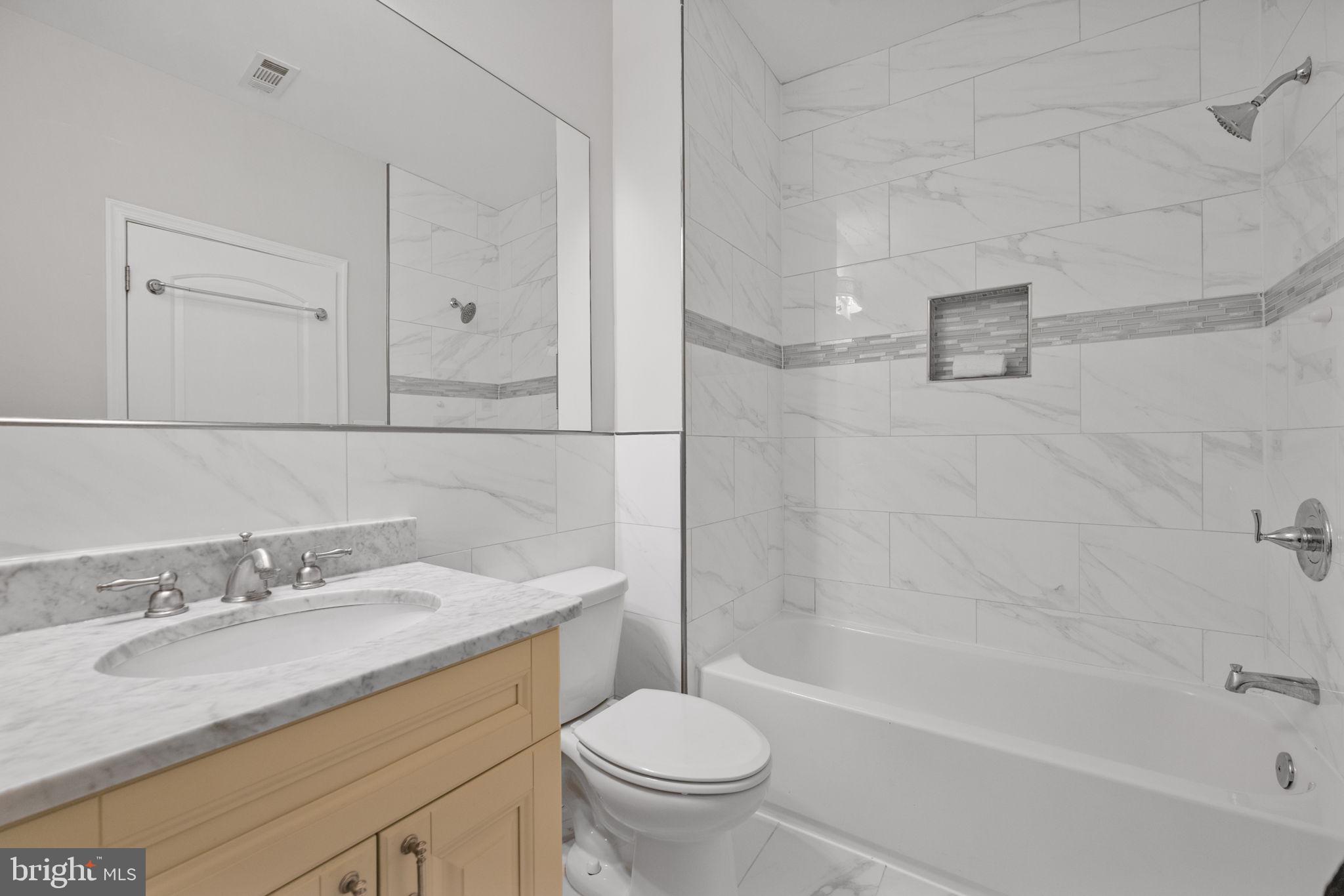 2420 West Rogers Avenue Baltimore, MD 21209 - Photo 38 of 67 a bathroom with a granite countertop sink a toilet and shower